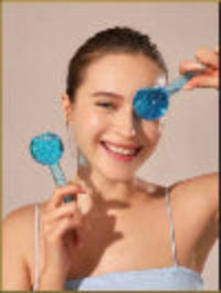 Woman holding a blue makeup tool against a plain background